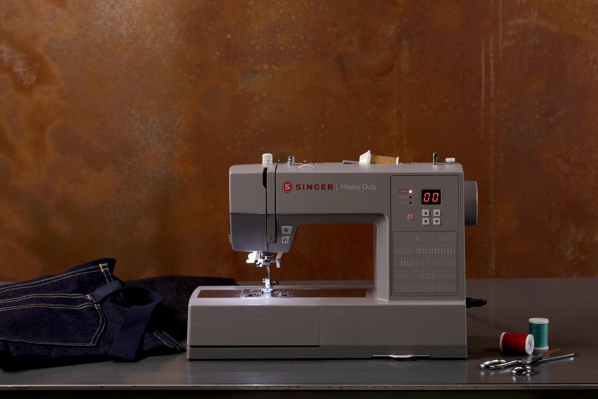Singer HD6605C sewing denim in a creative workspace